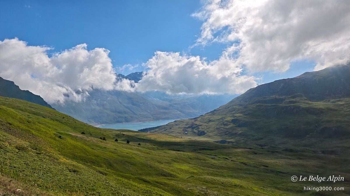 The Mont-Cenis lake appears on the climb, turquoise under the clouds