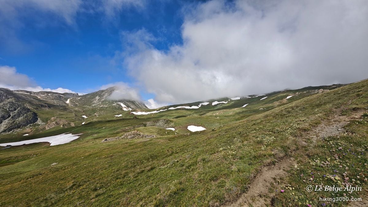 Early-season snow patches, the sky clearing gently