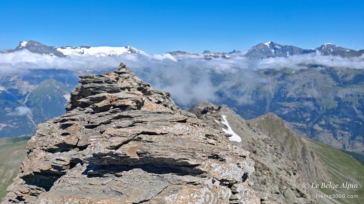 The summit cairn at 3162m, in its sea of clouds